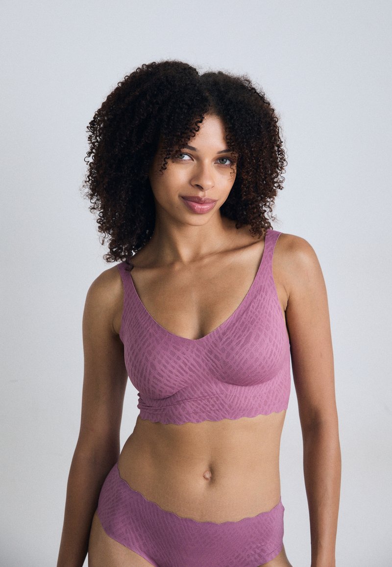 Mauve bralette and brief set with a textured pattern. Wide straps, V-neckline, and scalloped edges, made from a soft, stretchy material.