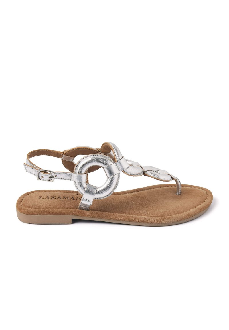 Zilverkleurige metallic platte sandalen met een cirkelvormig accentontwerp, voorzien van een tan faux suede binnenzool en een verstelbare enkelband.
