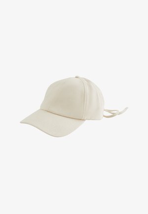 Casquette de baseball en coton couleur crème avec une visière incurvée, un tissu texturé, une sangle arrière ajustable et un détail de bouton sur le dessus.