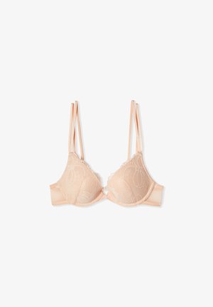Soutien-gorge en dentelle beige avec doubles bretelles fines réglables et fermeture à clip avant, présenté sur un fond blanc.