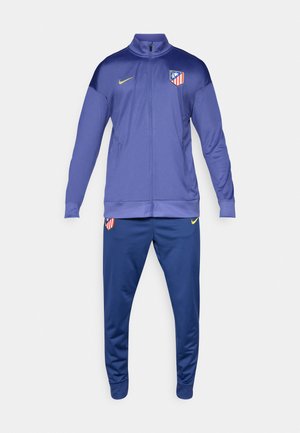 Fato de treino roxo com casaco com fecho, apresentando um colarinho alto e bolsos laterais. Inclui calças azuis, ambas com detalhes de logotipo.