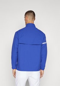 J.LINDEBERG Sports HEATH - Lauko striukė - clemantis blue
