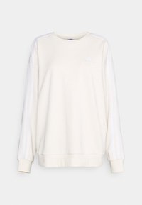 Felpa beige chiaro con strisce laterali bianche, collo a giro, maniche lunghe e un piccolo logo sul petto. Realizzata in tessuto morbido.