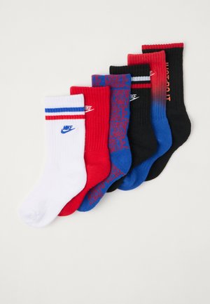 Επτά ζεύγη κάλτσες Nike σε λευκό, κόκκινο, μπλε και μαύρο. Ραμπαριστή υφή, με λογότυπα, ρίγες και σχέδια. Διαφορετικός χρωματικός διαχωρισμός.