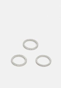 Three silver rings, featuring alternating rows of small and larger clear stones, with a smooth, polished finish and circular shape.