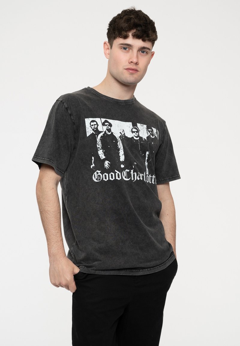 Black graphic t-shirt in a relaxed fit featuring a faded texture and a front print of four figures with the text "Good Charlotte" below.
