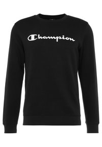 Svart sweatshirt i bomull, med långa ärmar, rundad hals och vit "Champion"-logotyp på framsidan. Slät textur och enkel design.