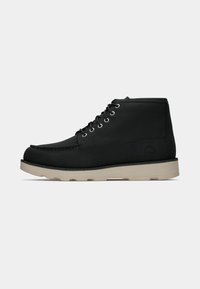 Black ankle boots featuring a suede upper, round toe, six metal eyelets, and a beige rubber sole with a textured pattern.