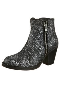 Bottine noire couverte de paillettes argentées avec fermeture éclair latérale et talon block, inclinée pour montrer le côté extérieur et la semelle.