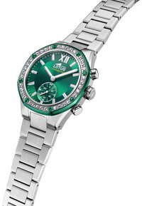 Reloj octogonal de acero inoxidable con esfera verde y acentos de cristal, que presenta una pulsera plateada y un subdial para los segundos.