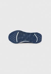 Dark blue sneaker outsole with textured waves and patterned grip, featuring white accents and solid rubber construction.