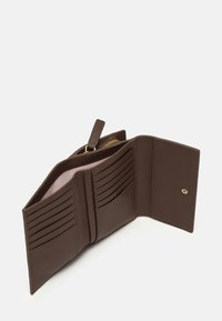 Brown leather wallet features multiple card slots, a zippered compartment, and a snap closure. Interior is lined in light pink.
