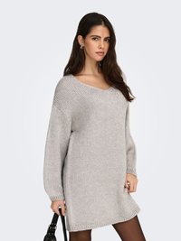 Gray knitted sweater dress with a V-neck, oversized sleeves, and ribbed hem. Smooth texture and relaxed fit, suitable for layering.