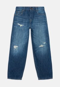 Sinine denim püksid lõdva istuvusega, kulunud laigud mõlemal jalal, klassikaline viie tasku stiil ja nööp sulgemine vööl.