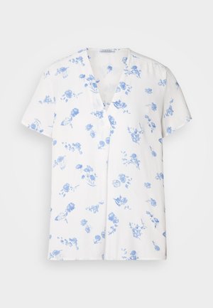 Camisa blanca de manga corta con escote en V, adornada con un patrón floral azul. Confeccionada en una tela ligera y con un corte relajado.
