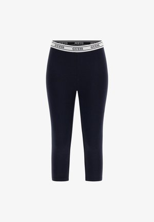 Marineblå leggings med en tætsiddende pasform og et hvidt elastisk liv med "GUESS" trykt. Fremstillet af et glat, strækbart stof.