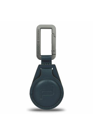 Navy leather keychain with a circular body and metal rectangular clip adorned with "Porsche Design" engraving. Smooth texture, minimalist design.
