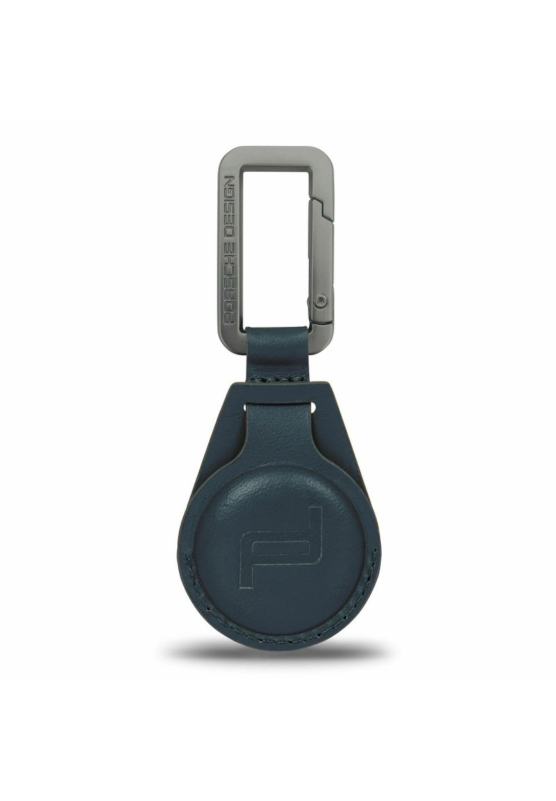 Portachiavi in pelle blu marino con corpo circolare e clip rettangolare in metallo decorato con incisione "Porsche Design". Texture liscia, design minimalista.