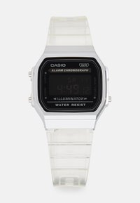 Montre numérique avec un bracelet en silicone transparent et un cadran rectangulaire noir. Possède des accents blancs, une fonction alarme et un indicateur de résistance à l'eau.