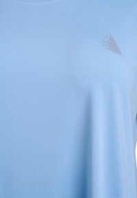 Sky blue athletic T-shirt made of lightweight fabric, featuring a round neckline and a subtle patterned accent on the left side.
