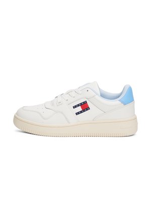 White low-top sneaker with light blue heel, cream sole, and Tommy Jeans logo patch on side.