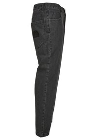 Sorte denim jeans med slim fit og tapered ben. Har en baglomme med et broderet logo. Solid stof med subtil tekstur.