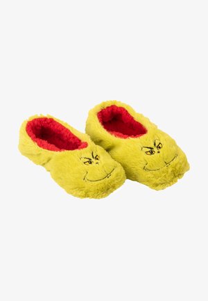 Yellow plush slippers with a soft, furry texture, featuring red lining and a Grinch face embroidered on the front. Closed-back design.