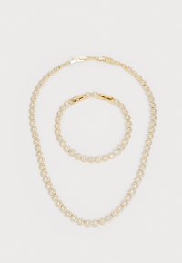 Gold-tone jewelry set featuring a necklace and bracelet, each adorned with round faux gems in a repeating pattern.