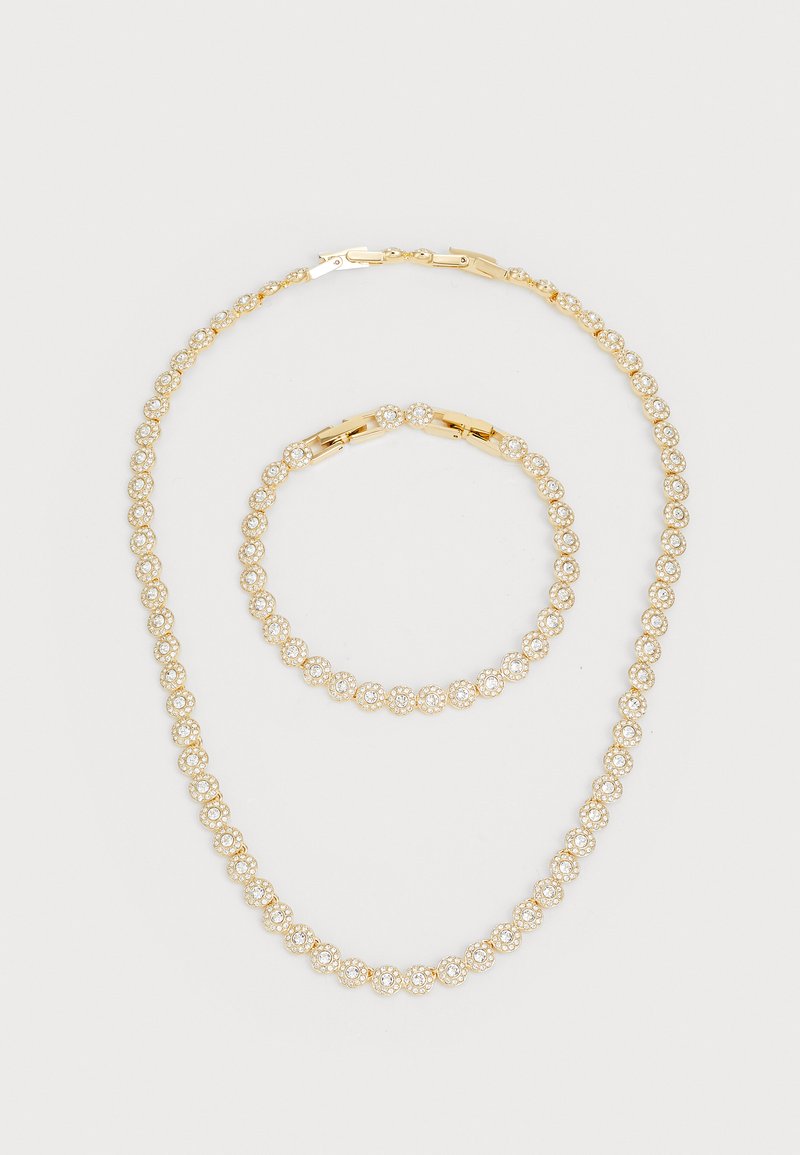Gold-tone jewelry set featuring a necklace and bracelet, each adorned with round faux gems in a repeating pattern.