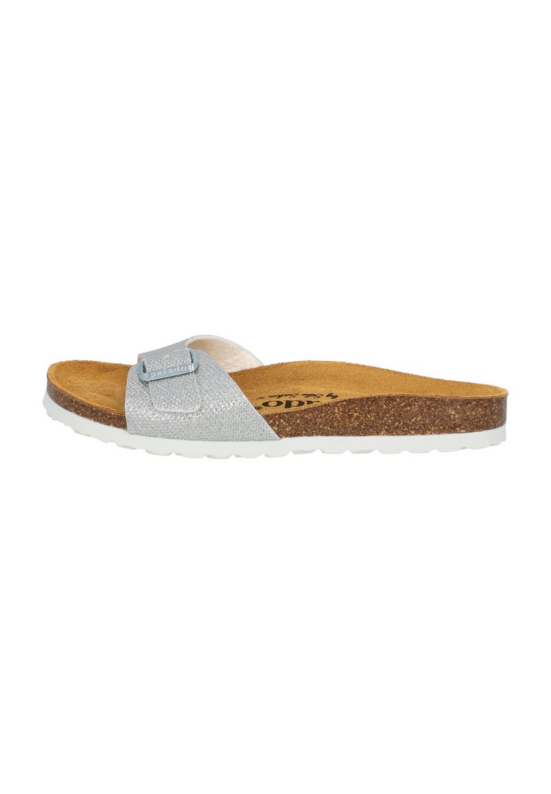 Silver sparkly slide sandal with cork footbed, white rubber sole, and adjustable strap featuring a metallic accent detail.