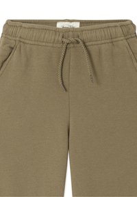 Oliivirohelised dressipüksid elastse vöökohaga, reguleeritava kinnitusnööriga ja küljetaskutega. Pehme, tekstuuriga kangas.