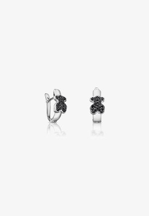 Silver-tone earrings shaped like teddy bears, featuring black stones embedded for texture and detail. Hinged closure for secure wear.