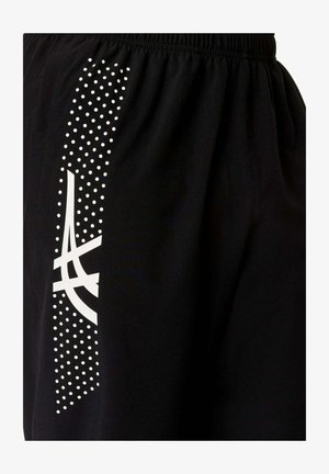 Schwarzer Stoff mit vertikaler, weiß gepunkteter Linie und fettem, abstraktem weißen Logo-Design, mit elastischem Bund oben.