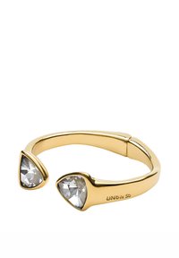 Pulsera de brazalete ajustable en tono dorado con dos piedras preciosas triangulares claras en cada extremo, superficie lisa y detalle sutil de marca.