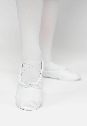 White ballet shoes made of soft fabric, featuring elastic straps that crisscross, with a rounded toe and gathered edges.