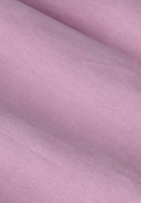 Cotton fabric in soft lavender color, featuring a smooth texture with a subtle sheen and slight stretch, showcasing pleats and folds.