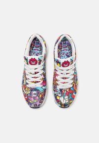 Multicolored sneakers featuring a vibrant graphic print, white laces, and a cushioned insole, with a reinforced rubber sole for durability.