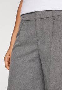 Grå skräddarsydda byxor i texturerat material, med slät front, sidofickor och rak bendesign.