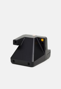 Black instant camera with a triangular design, featuring a prominent lens, a yellow power button, and a multicolored stripe on top.