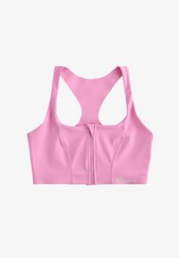 Sujeción deportiva rosa hecha de tela elástica, con cremallera frontal, tirantes anchos y textura suave. Logo impreso en la parte inferior derecha.