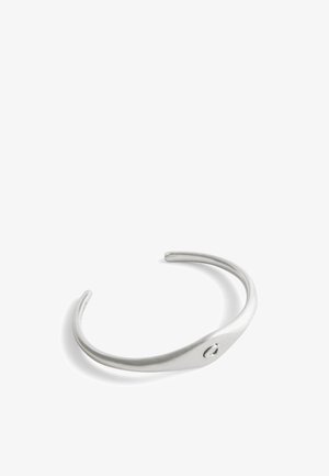 Silver metal cuff bracelet featuring a smooth, curved design with a small round accent detail. Minimalist and polished finish.