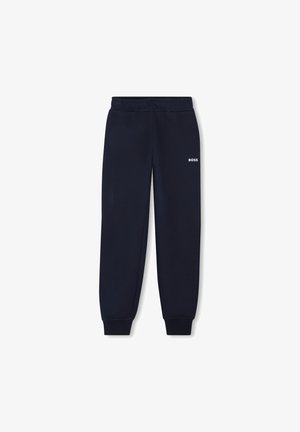 Pantalons de survêtement bleu marine avec une taille élastique et des poignets, arborant un logo blanc sur le bas de la jambe gauche. Tissu doux avec une texture lisse.
