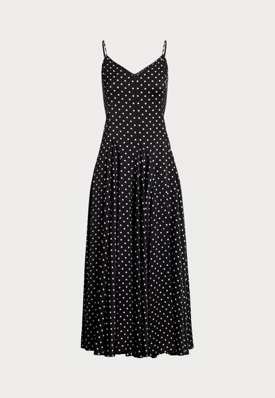 Vestido preto com bolinhas, com um corpete ajustado, saia rodada e alças finas ajustáveis, apresentando bolinhas brancas num padrão uniforme.