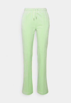 Light green women's fleece pants with front seams, elastic waistband, and drawstring detail.