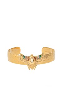 Gold-toned metal cuff bracelet with a hammered finish featuring a central eagle design adorned with colorful gemstones and an oval centerpiece.