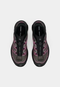 Black and gray athletic shoes featuring pink accents, textured fabric, lace-up design, and a sturdy rubber sole. Ortholite insole visible.