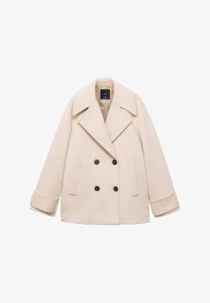 Beige double-breasted coat with large notched collar, two front pockets, and black buttons. Soft fabric and structured fit enhance the design.