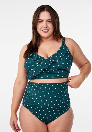 Taškuota bikini komplektas tamsiai žalia spalva, su volanėlių apatine dalimi ir reguliuojamomis petnešėlėmis bei aukštu juosmeniu. Lygi tekstūra ir prigludęs dizainas.