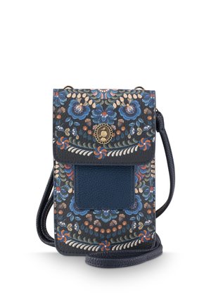 Small dark blue crossbody bag with floral pattern, front pocket, and decorative round metal clasp, shown upright with strap coiled below.