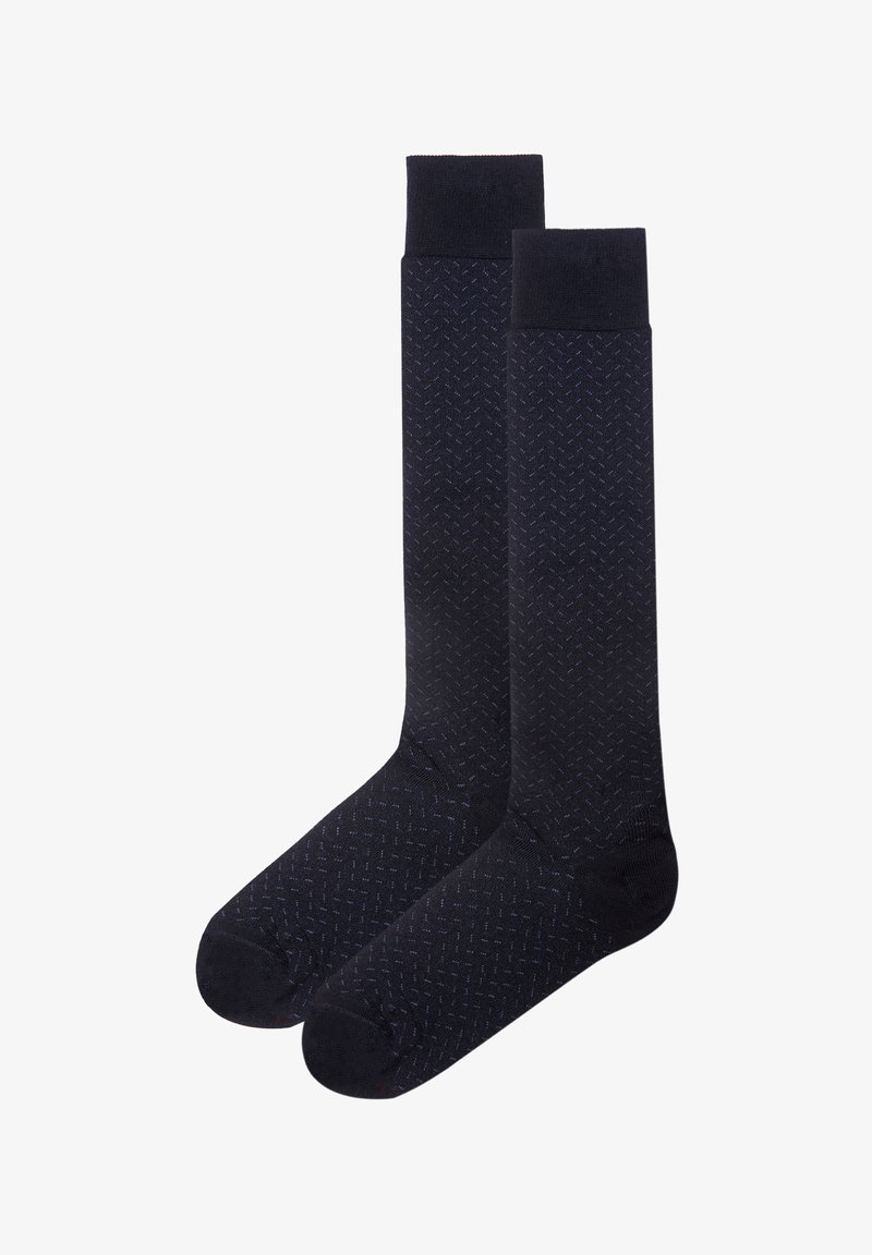 Marineblauwe sokken met een subtiel herringbonepatroon, gemaakt van een katoenen blend, met ribbels aan de bovenkant en versterkte tenen voor extra duurzaamheid.